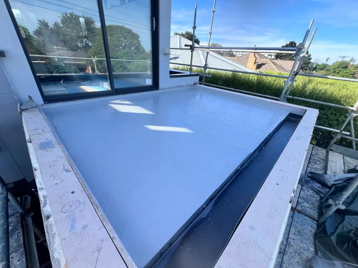 Balcony waterproofing membrane applied before exterior balcony finish
