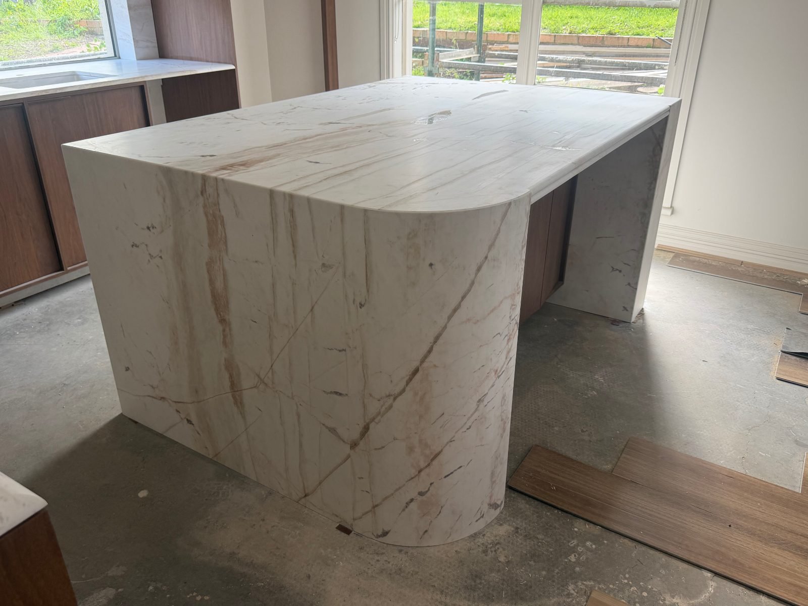 Pieris Dolomite stone benchtops and curved waterfall kitchen island installed by TN Stone in Keilor, Melbourne
