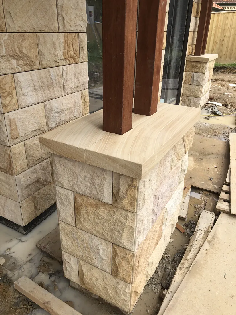Sandstone pieces accurately positioned on residential facade