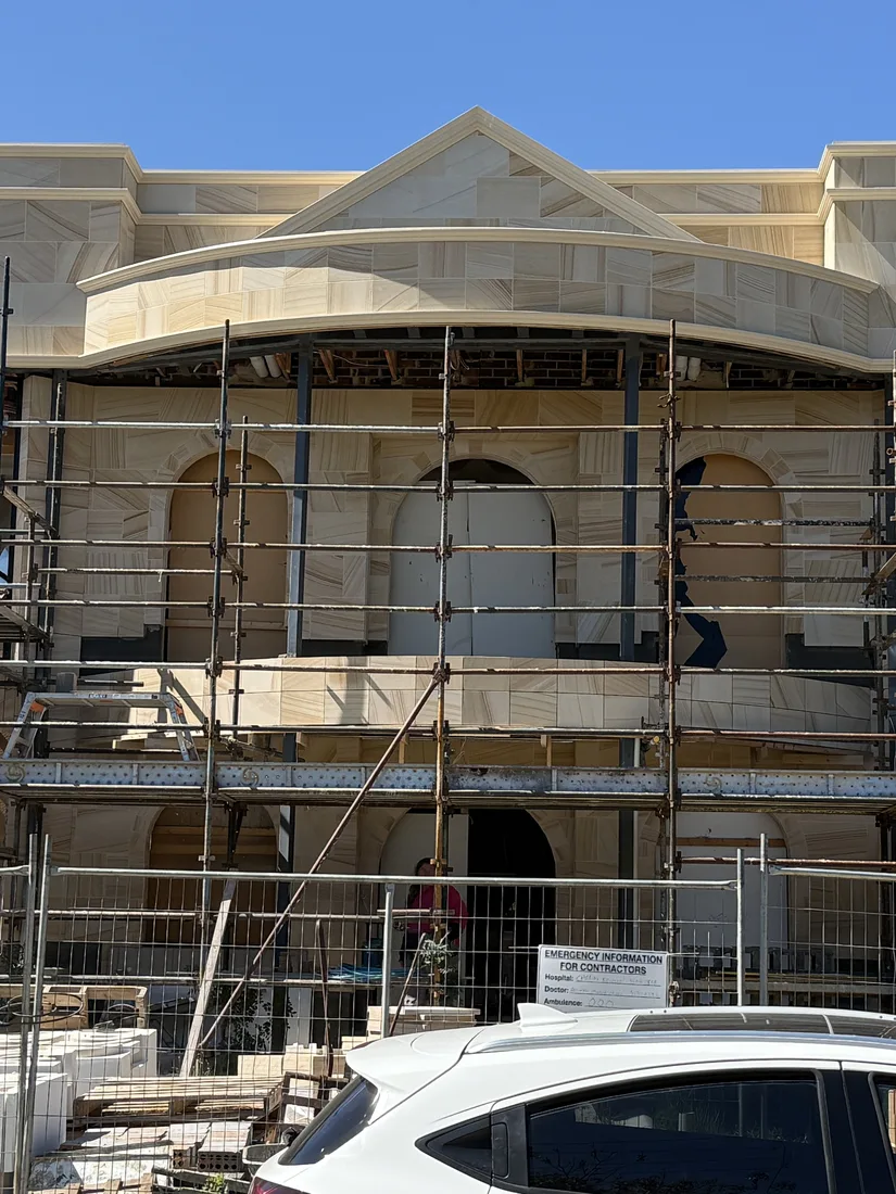 Sandstone façade installation in progress on the Brighton residence