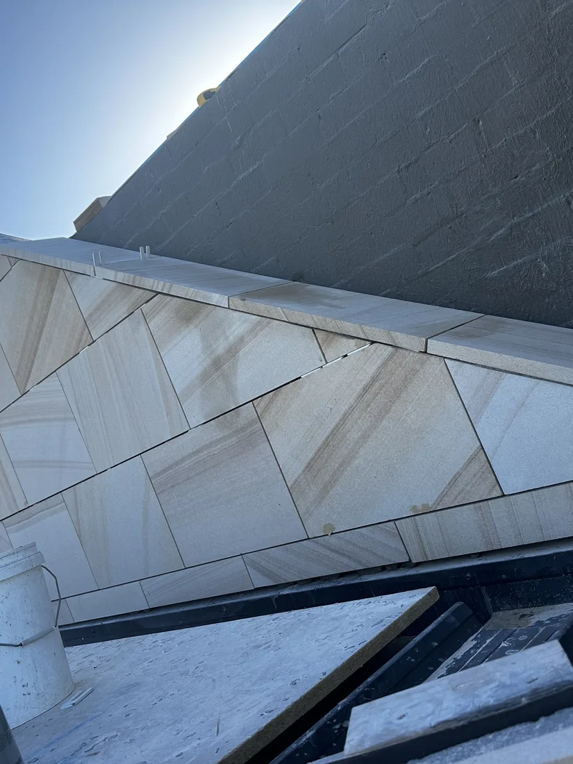 Precision-cut sandstone coping with aligned diagonal panel joints
