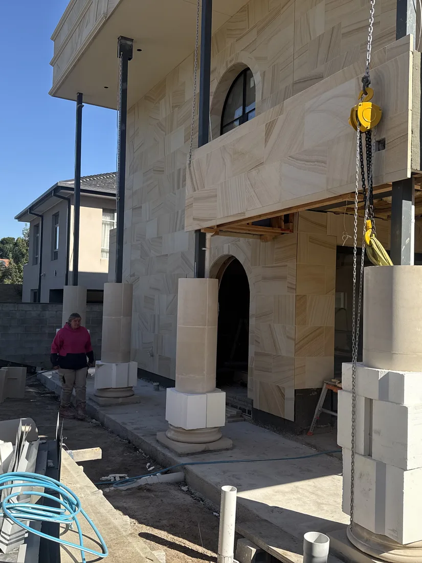 Wide view of the sandstone façade installation with feature columns