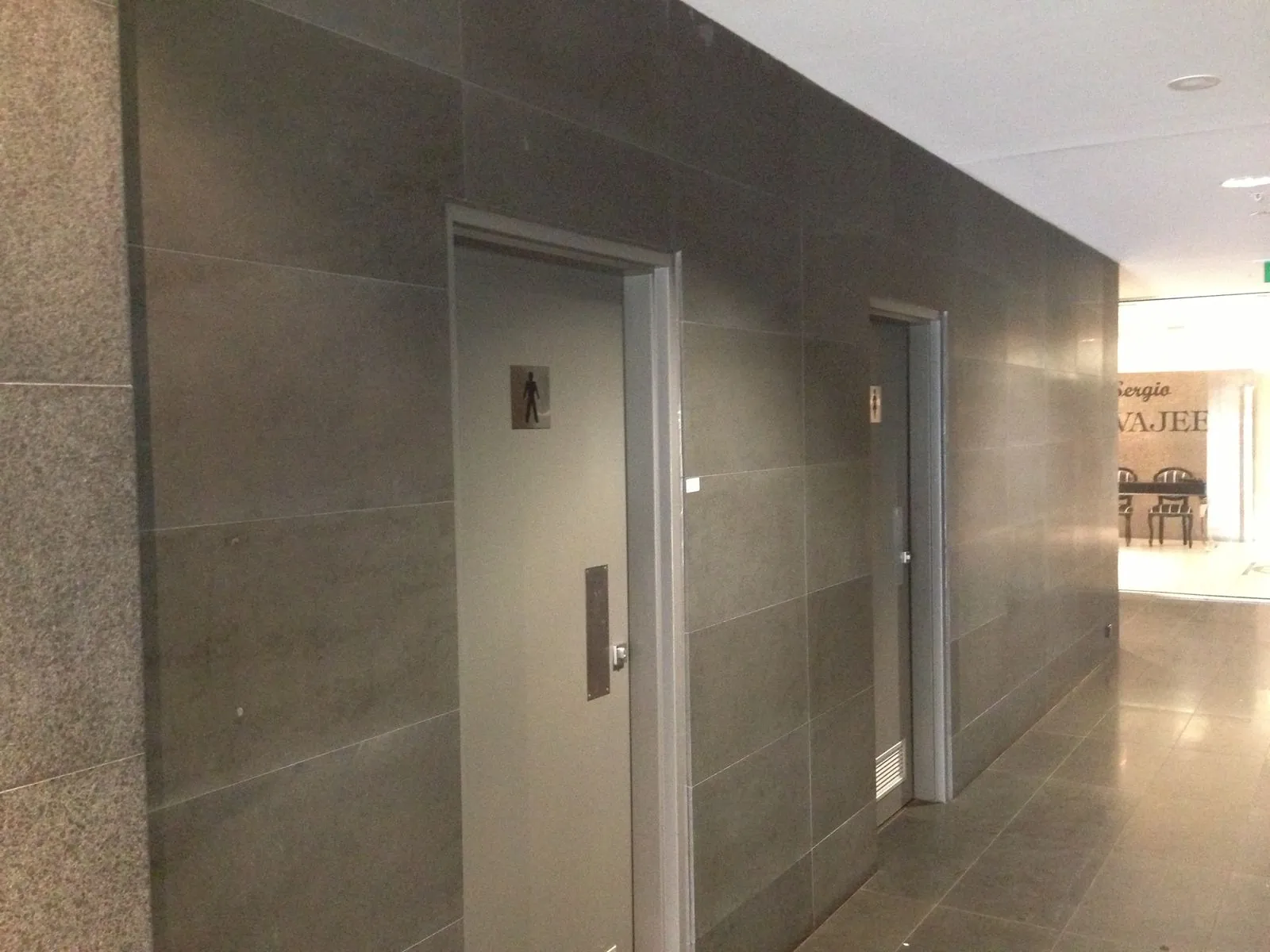 Granite flooring and cladding installed to a covered walkway between building entrances