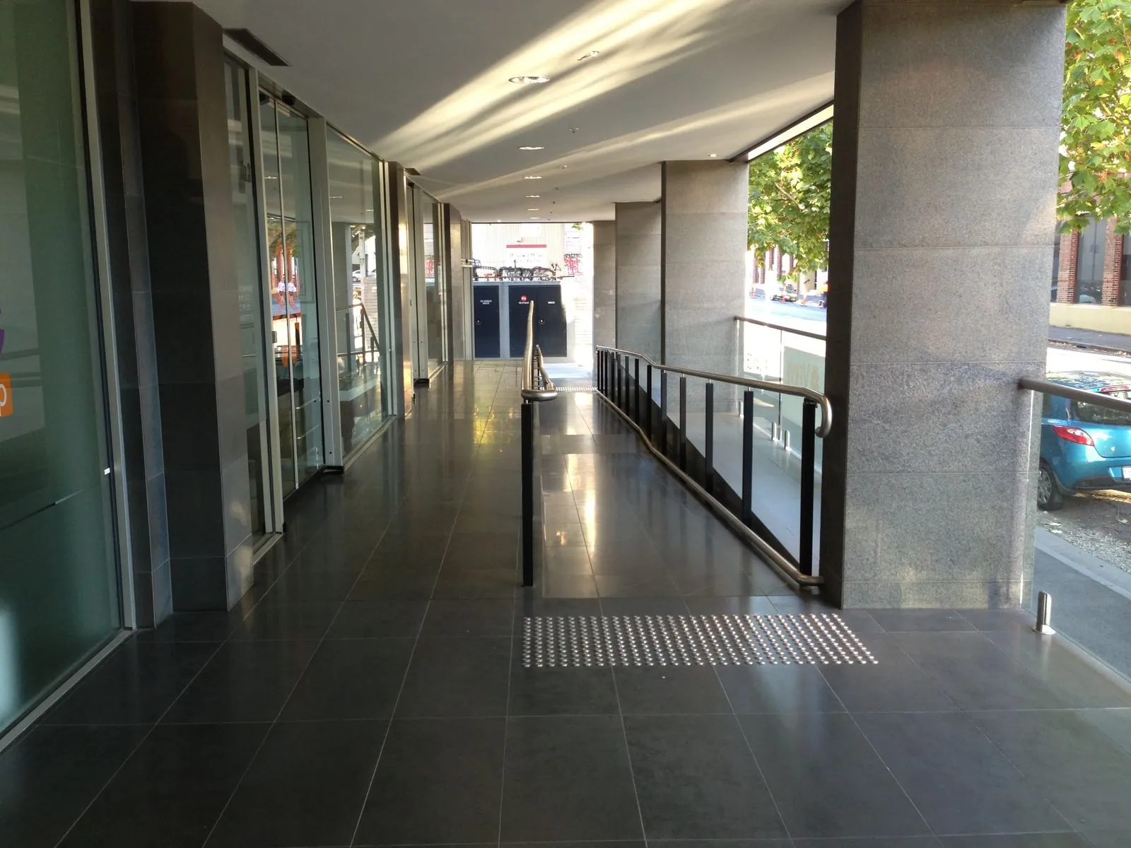 Granite-clad columns along an exterior walkway of a commercial building in Collingwood
