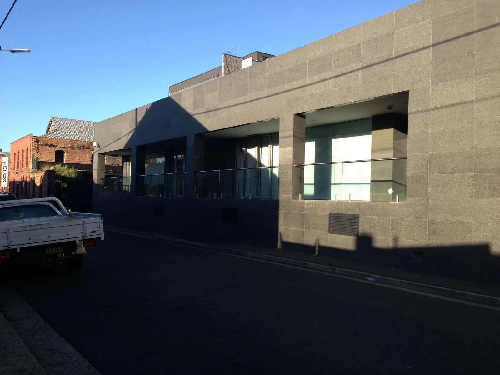 Flamed granite panel cladding to the entrance corner of a commercial car park building