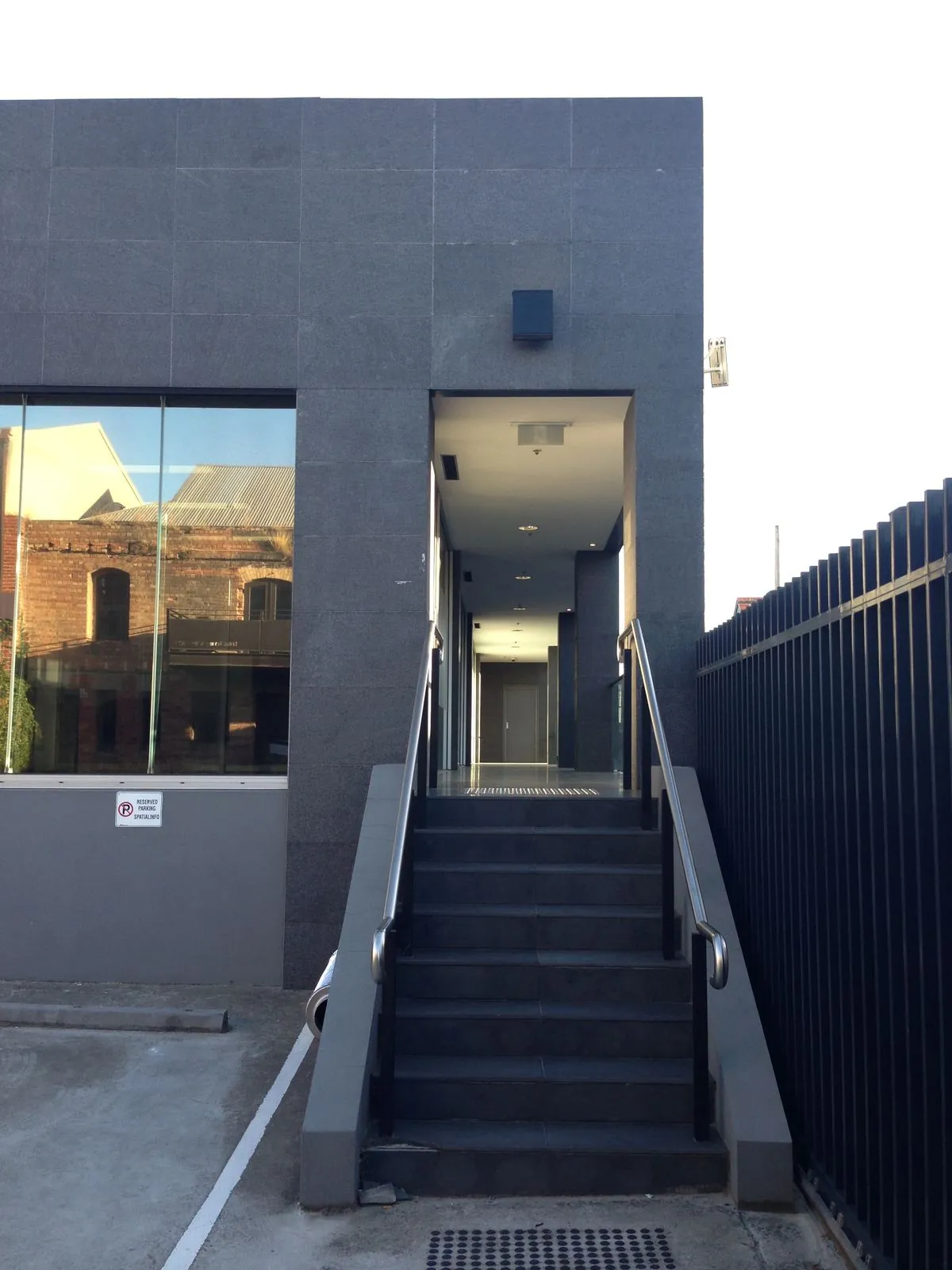 Granite-clad entry columns and stairway leading into the commercial building