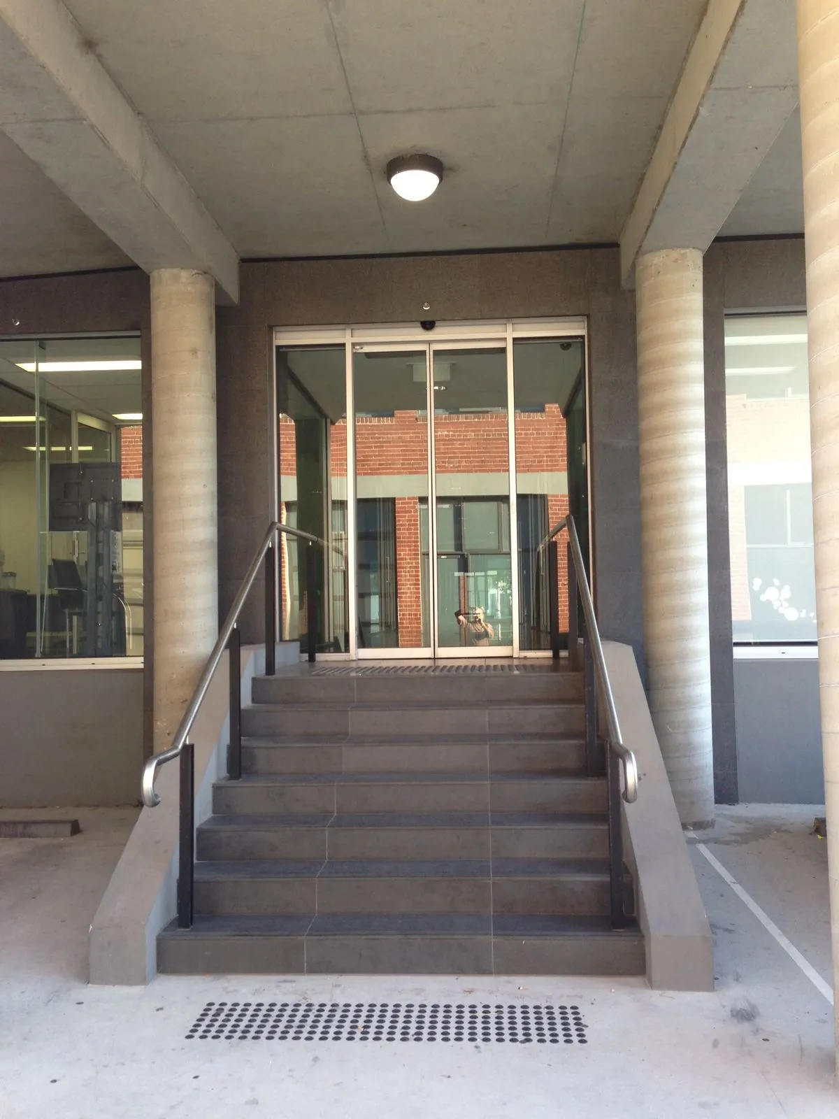 Granite panel cladding to the entry stairs and glazed entrance doors