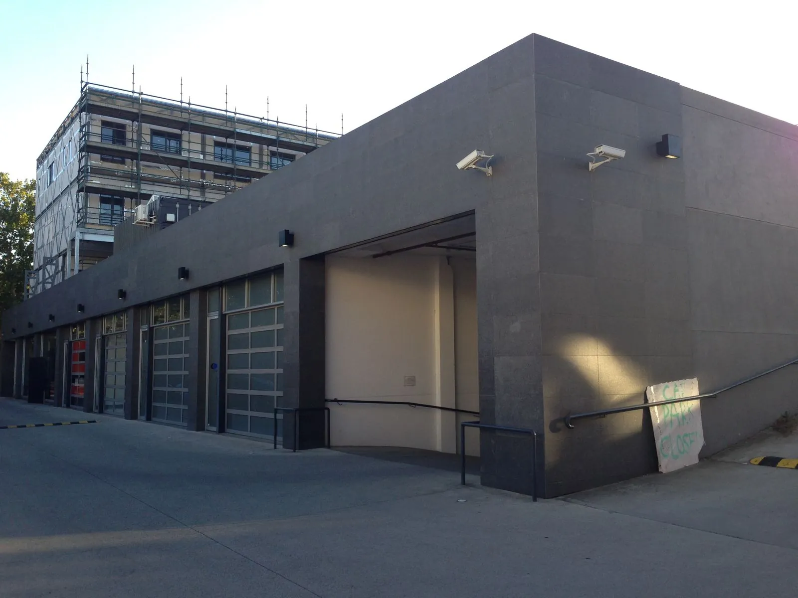 Flamed granite panel cladding to the corner of the building near the roller door entries