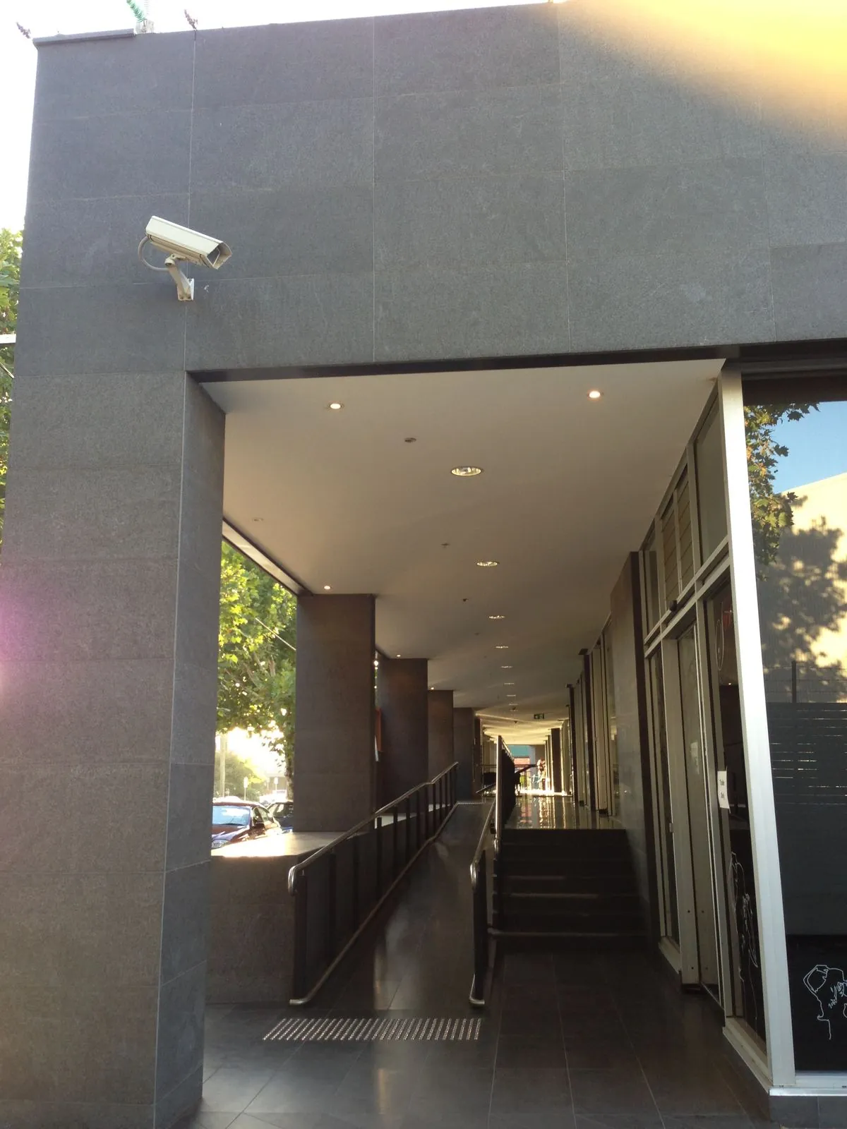 Granite-clad column and covered walkway on the exterior of the commercial building
