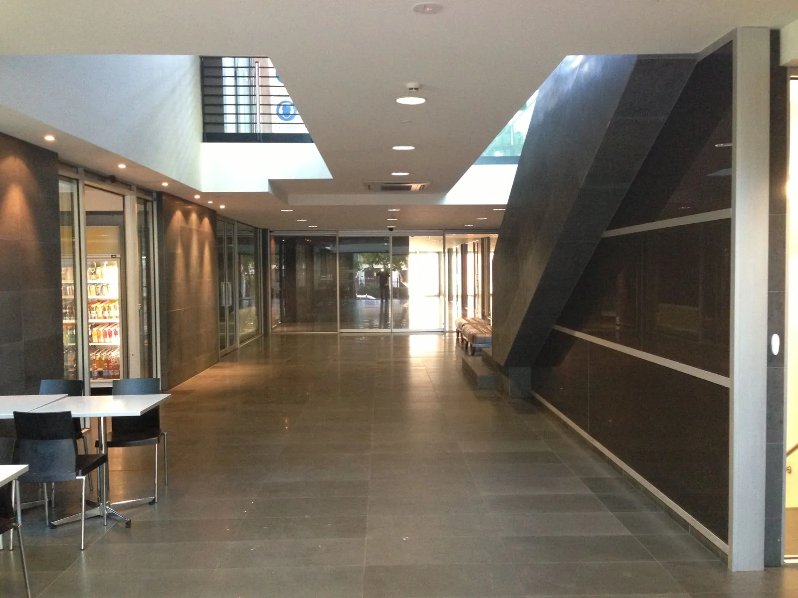 Bluestone flooring installed along an interior corridor and cafe area