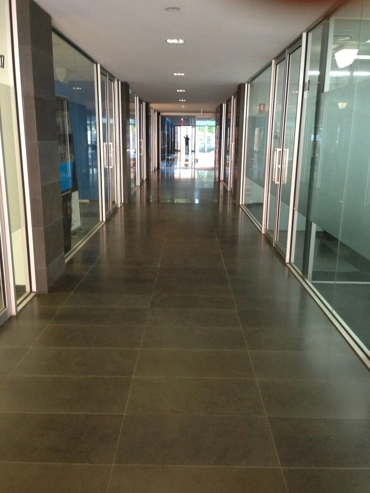 Bluestone flooring and glazed corridor installed inside the commercial building