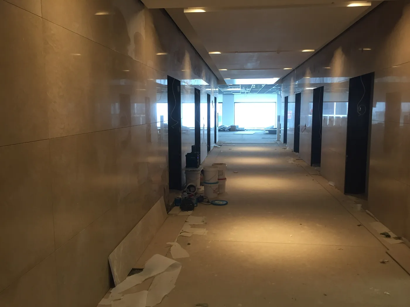 Commercial Crema Marfil marble wall installation at Collins Place lift lobby