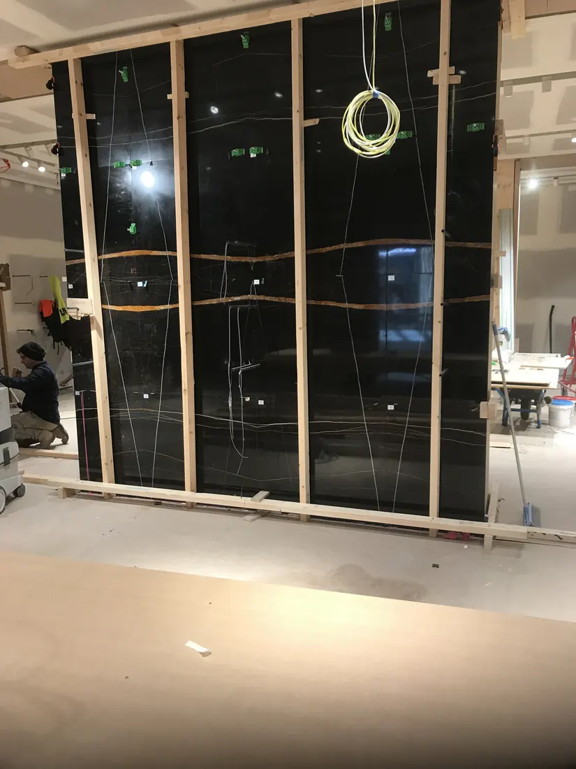 Lightweight honeycomb backed marble panels aligned for retail fit-out