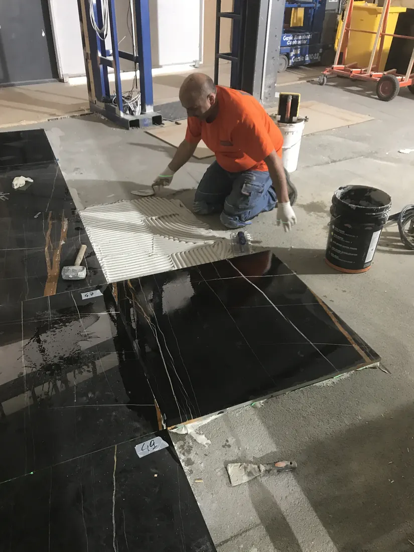 Marble floor installation using careful adhesive bedding and alignment