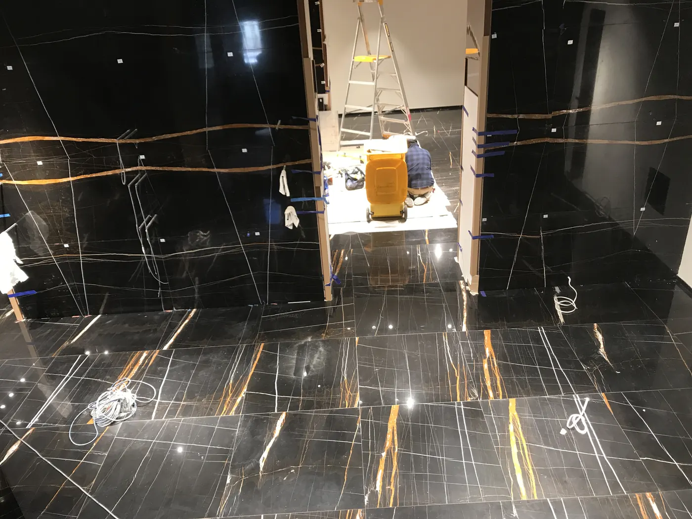 Black marble wall and floor finishes installed in luxury retail store