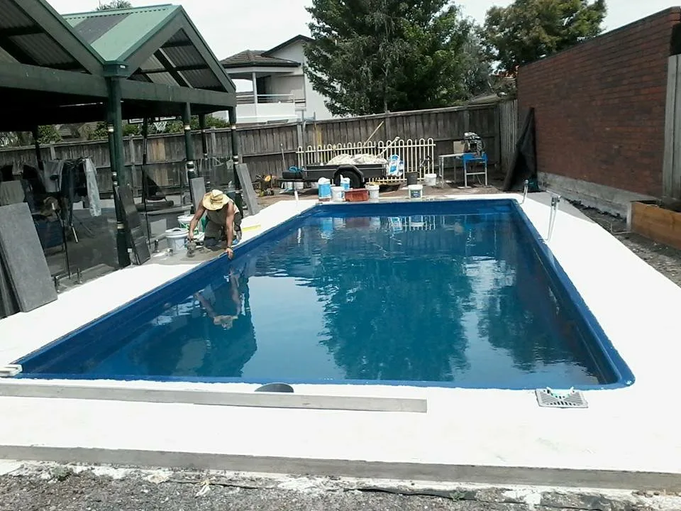 Granite pool coping installation showing natural stone variation