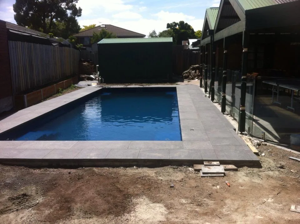 Granite pool coping and glass fencing viewed from the residence