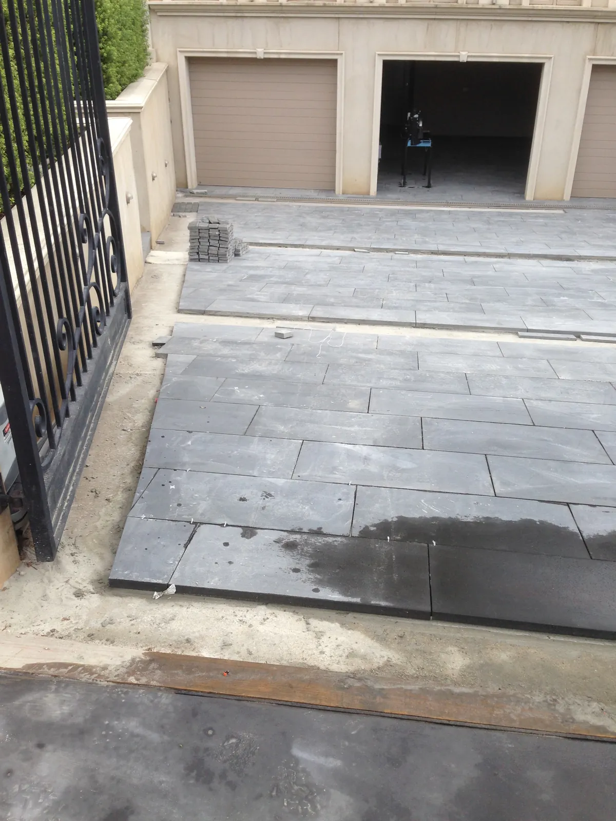Bluestone wall cladding installed to an exterior wall near the entry gate