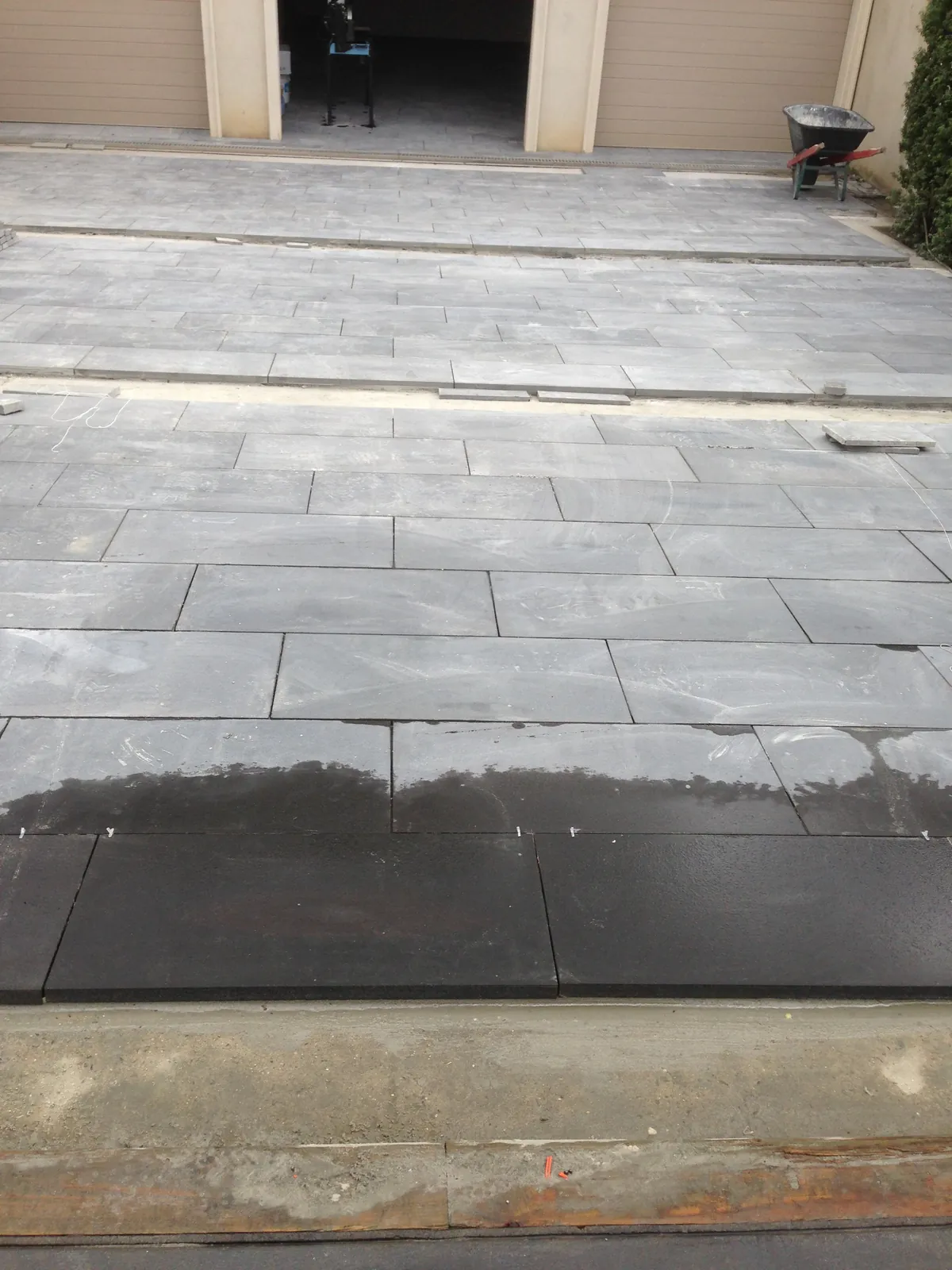 Bluestone paving installation across the driveway approaching the garage
