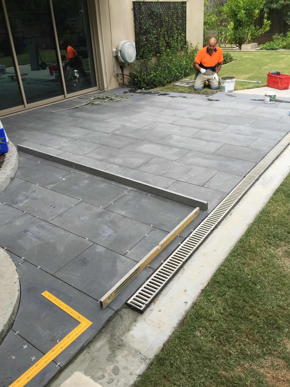 Bluestone paving installation to the rear patio with drainage channel detail