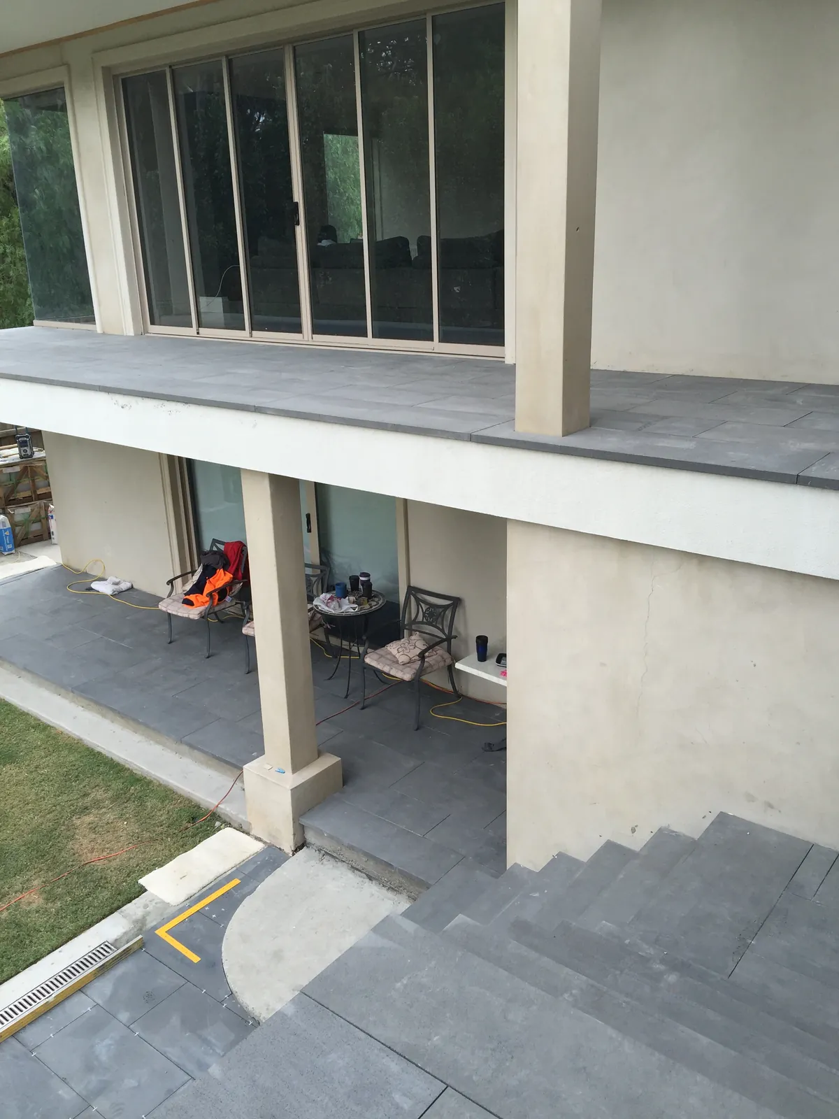 Bluestone coping installed to the upper balcony with paved patio below