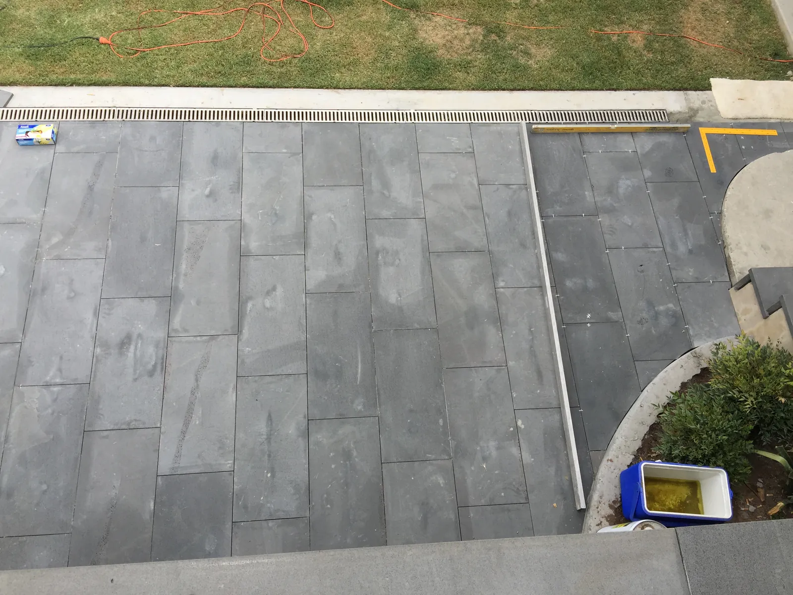 Bluestone paving installed around a curved garden bed on the rear patio