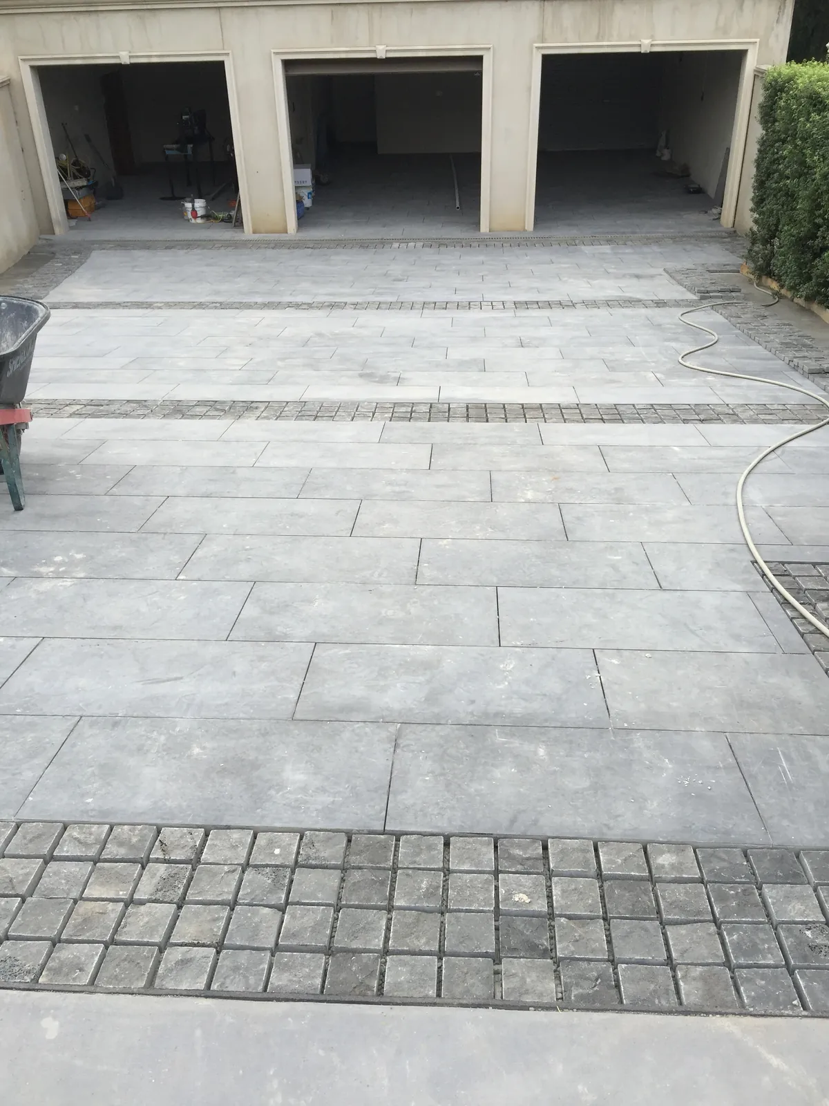 Completed bluestone driveway paving leading to the garage entrance