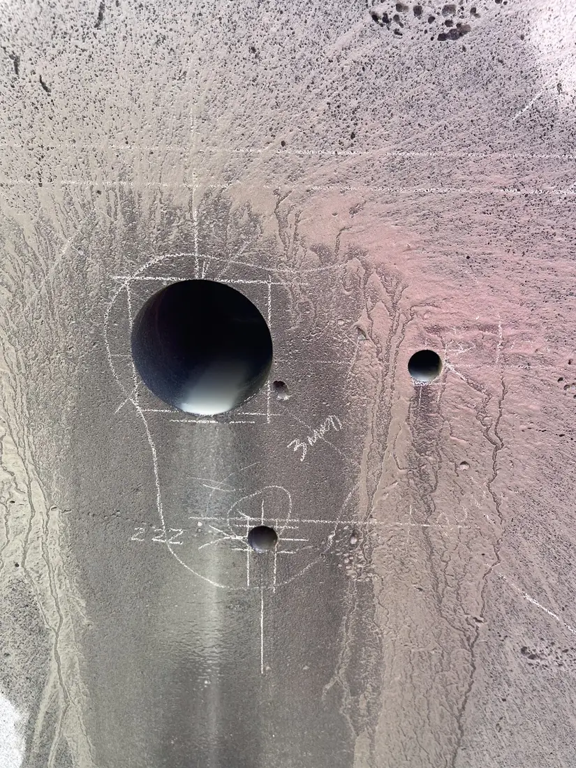 Close-up detail of set-out marks and drilled fixing points on heritage bluestone