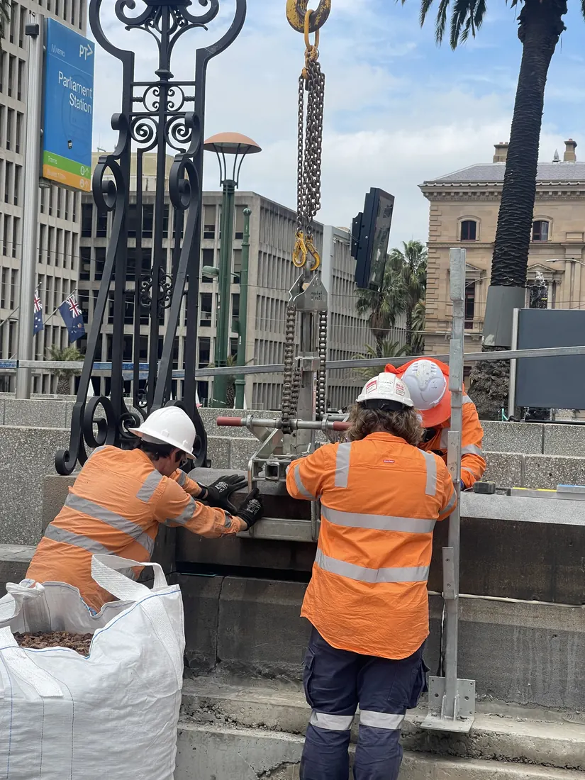 Parliamentary fence installation with precise stone base detailing