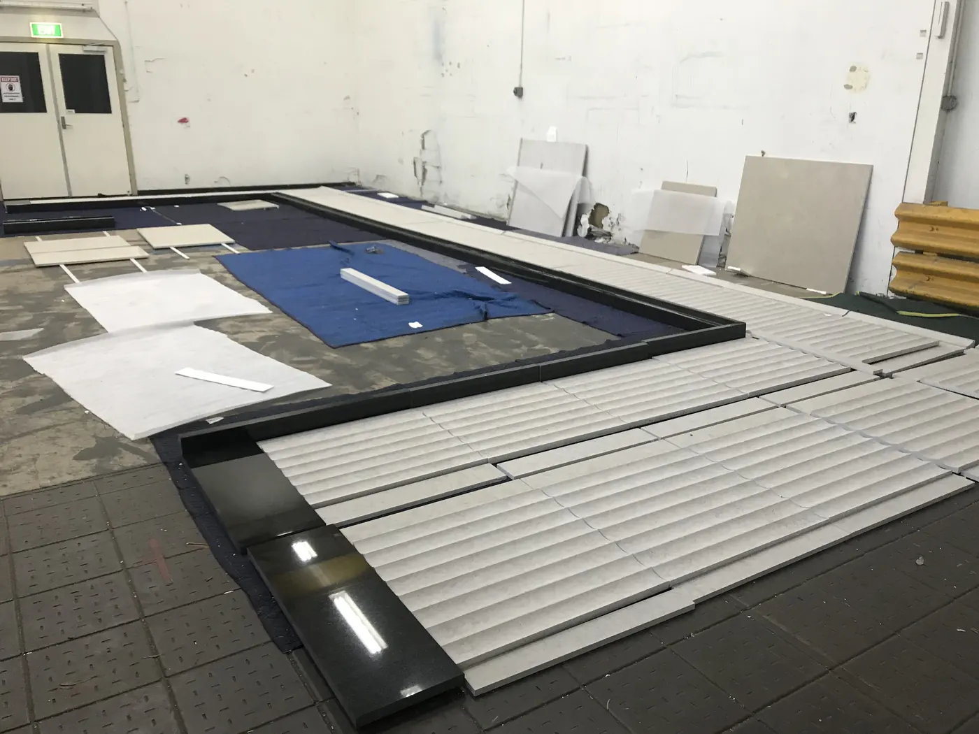 Marble wall panel installation for premium airport retail fit-out
