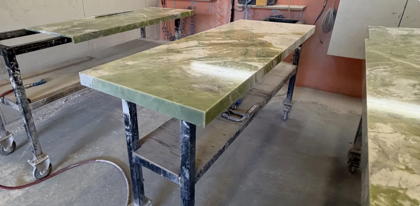 Polished stone benchtop slab on fabrication stand at TN Stone workshop