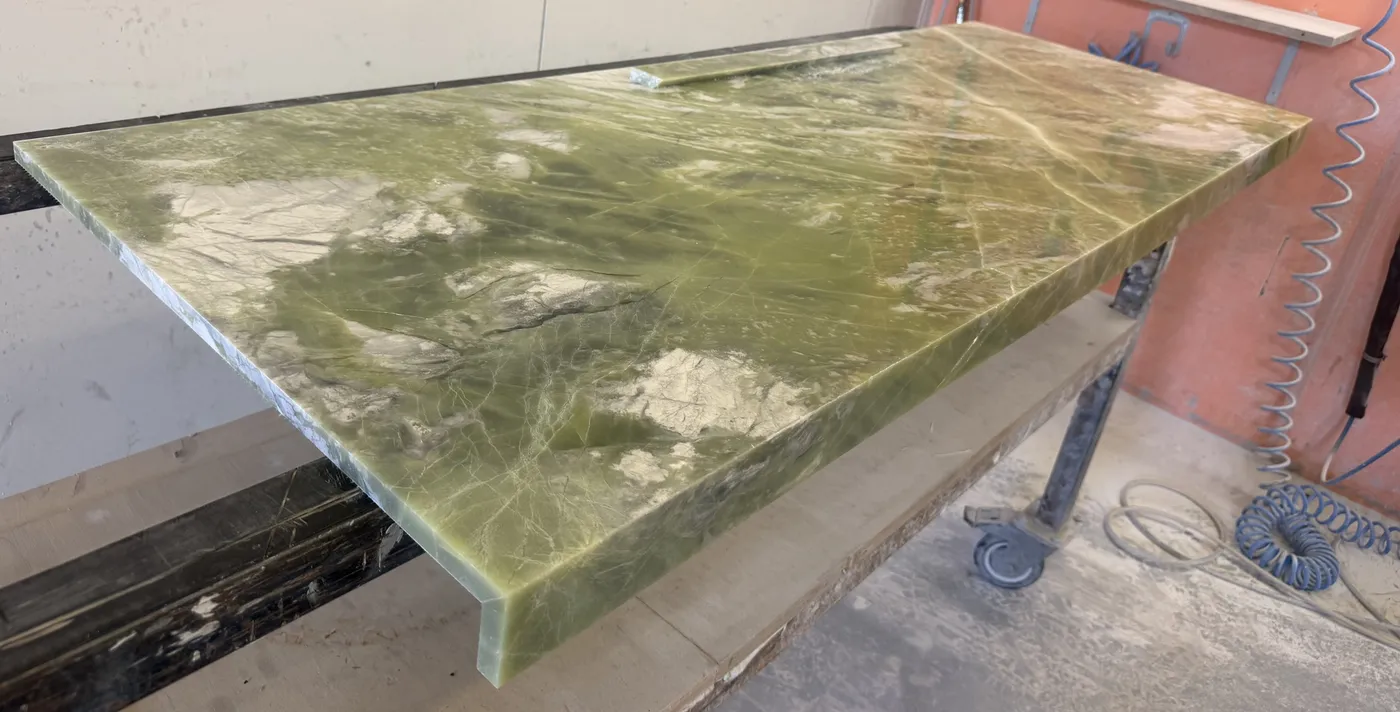 Stone benchtop on workshop stand ready for edge finishing