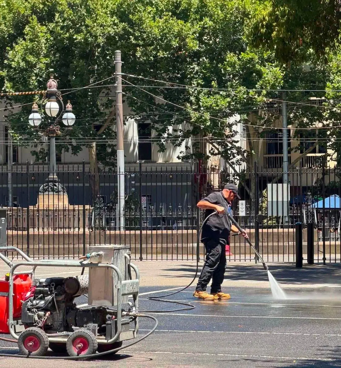 Pressure washing public footpath, Melbourne