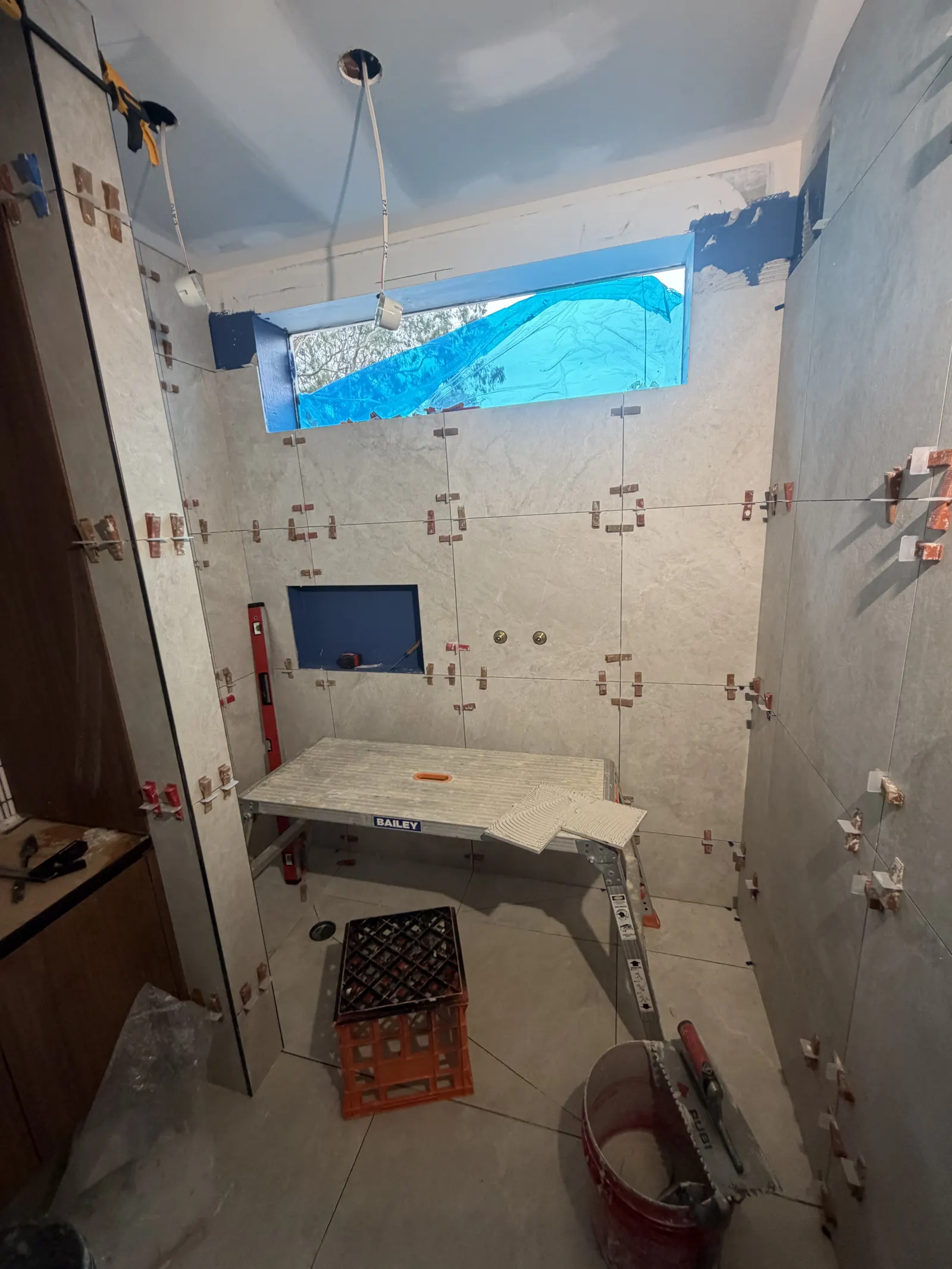 Tile setout and levelling system in shower recess