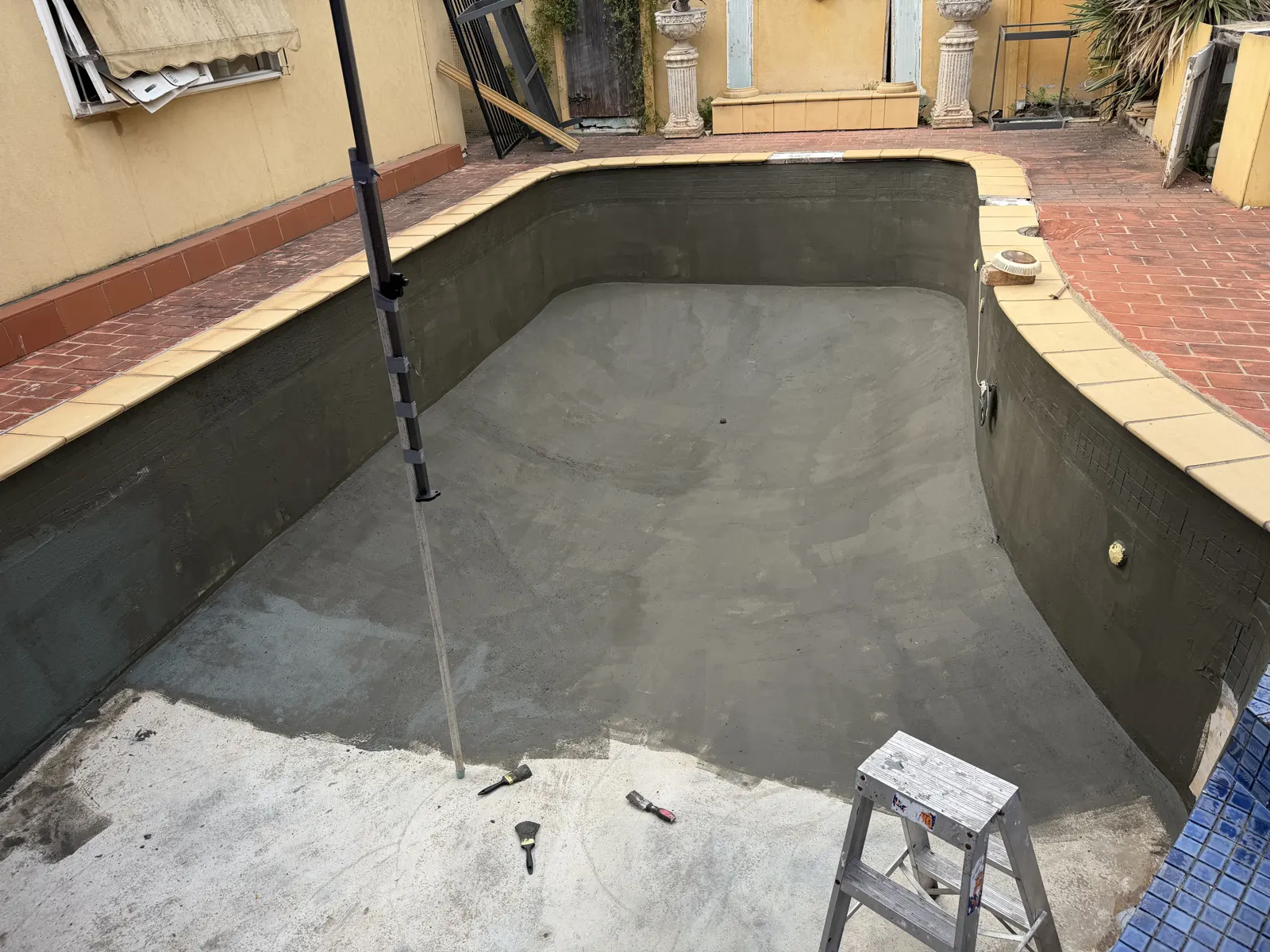 Waterproofing membrane applied across Moorabbin pool shell before tiling