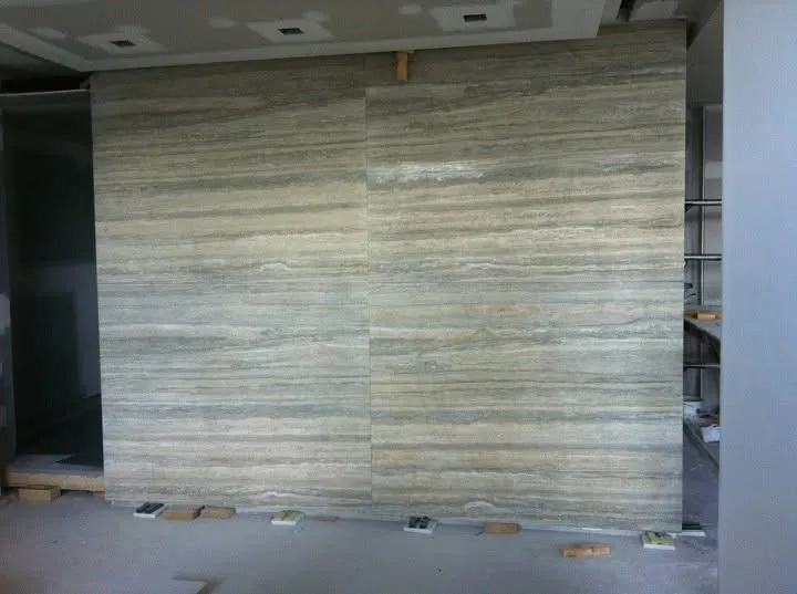 Butt-jointed travertine slab panels with matched veining, no visible grout line